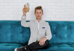 Sitting Man raising glass of champagne for toast